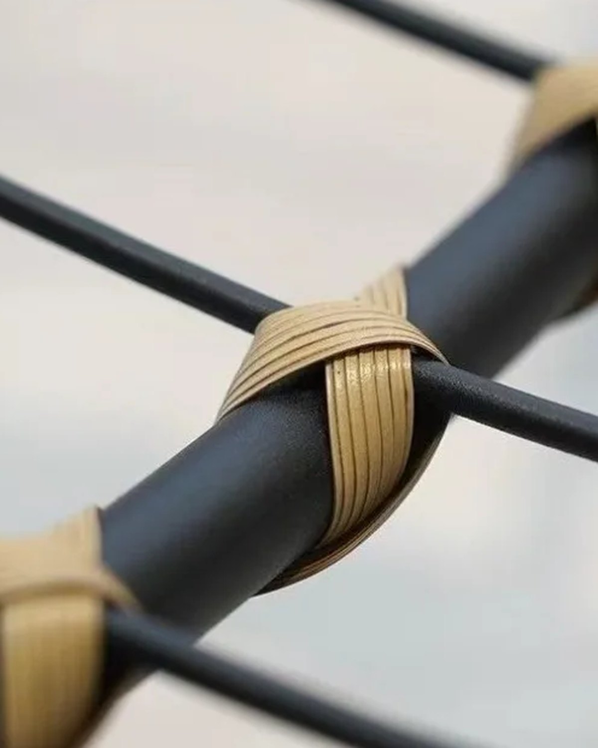Close-up of the frame and legs of The Verse Rattan Rocking Chair