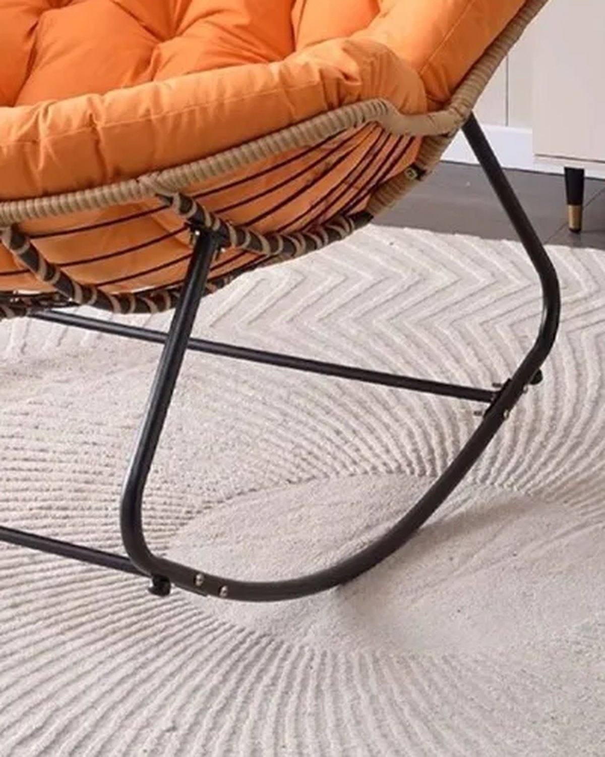 Close-up of the rockers of The Verse Rattan Rocking Chair