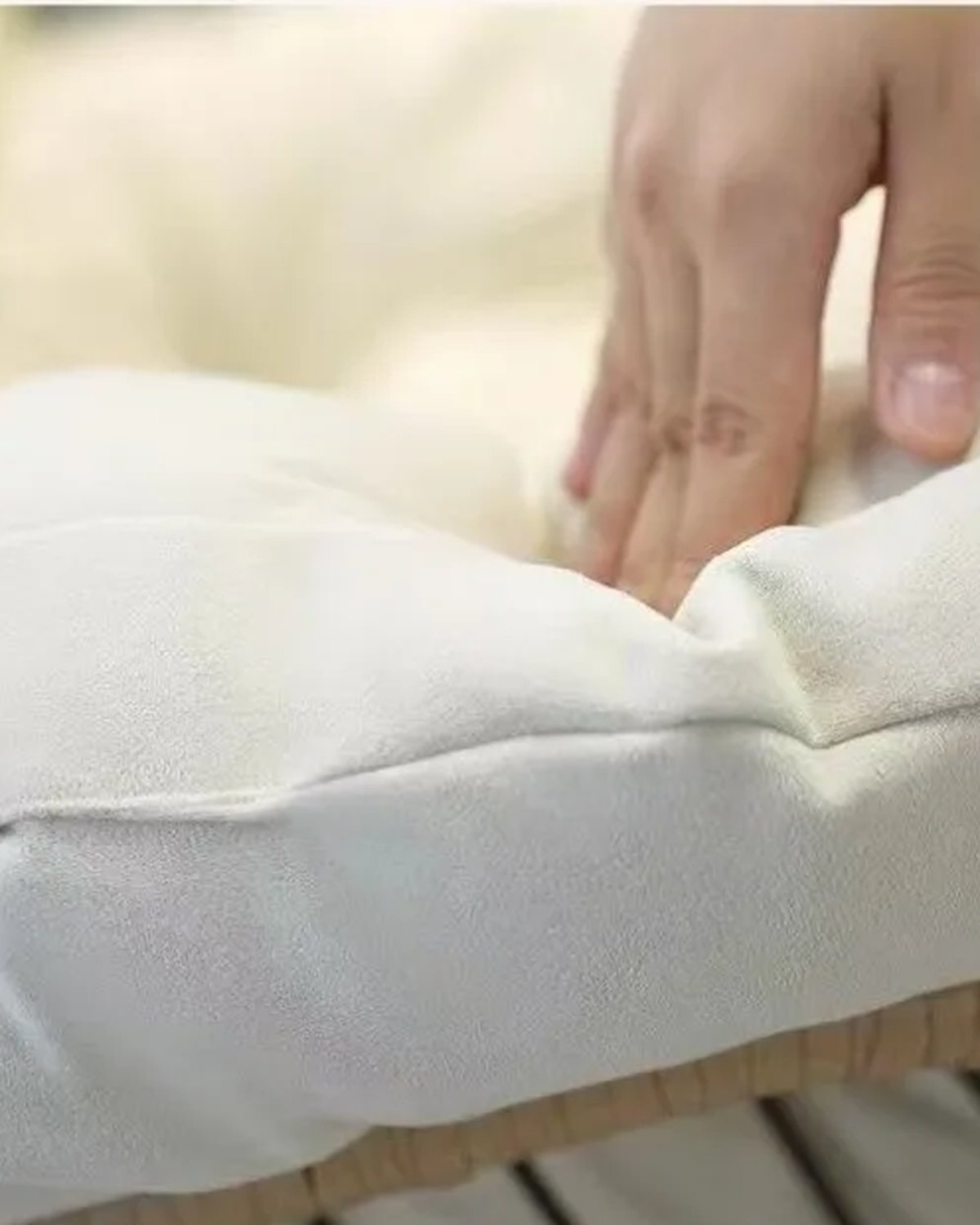 Close-up of the seat cushion of The Verse Rattan Rocking Chair